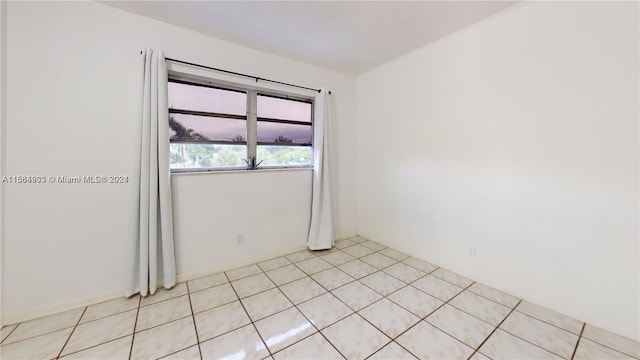 spare room with light tile flooring