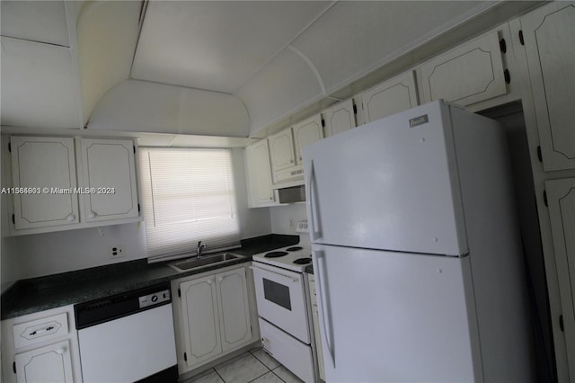 kitchen with sink, white cabinets, light tile floors, and white appliances