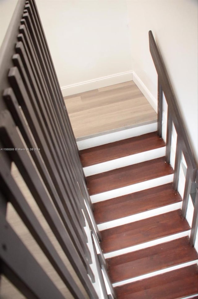 staircase with dark wood-type flooring