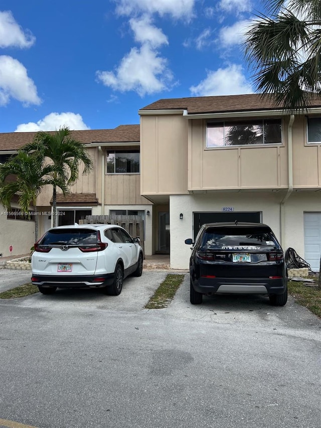 multi unit property featuring a garage