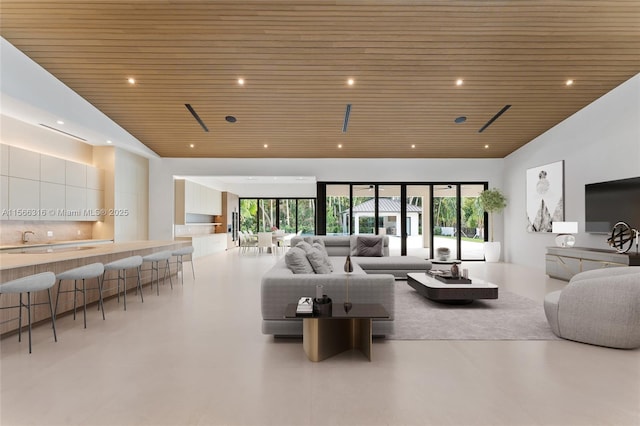 living area featuring wooden ceiling, high vaulted ceiling, a wealth of natural light, and recessed lighting