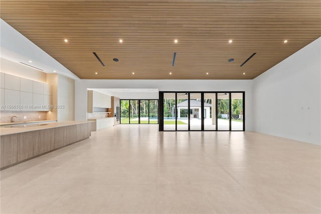 empty room with recessed lighting and wooden ceiling