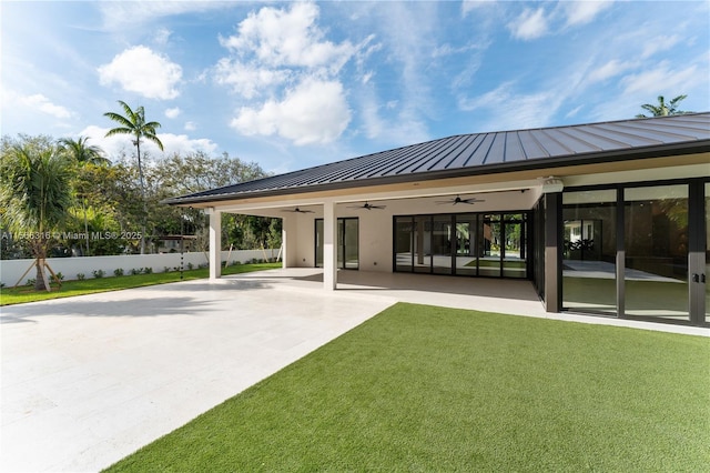 exterior space with fence and a ceiling fan