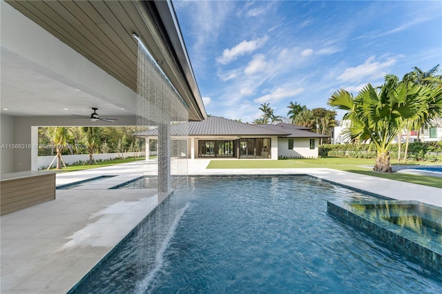 view of swimming pool featuring a ceiling fan, a pool with connected hot tub, and a patio area