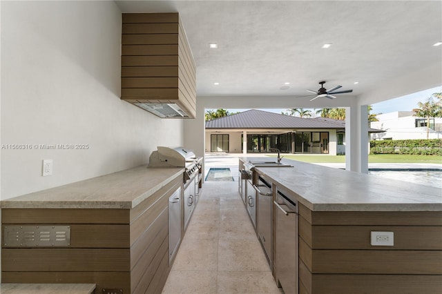 view of patio with a ceiling fan, a sink, grilling area, and area for grilling