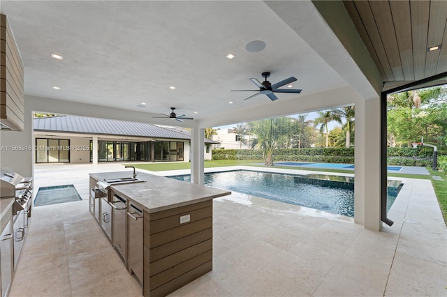 view of swimming pool featuring a patio area, a ceiling fan, a fenced in pool, and area for grilling