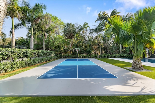 exterior space with basketball hoop and fence