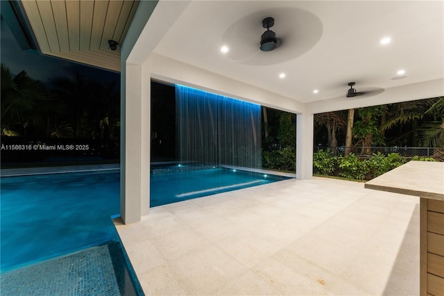 view of swimming pool featuring ceiling fan, a patio, fence, and a fenced in pool