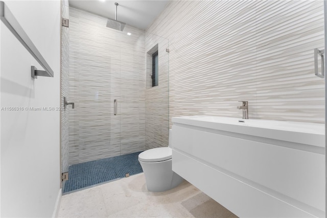 bathroom featuring a stall shower, tile walls, vanity, and toilet