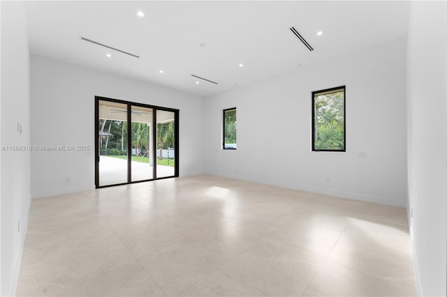 unfurnished room with recessed lighting, visible vents, and baseboards