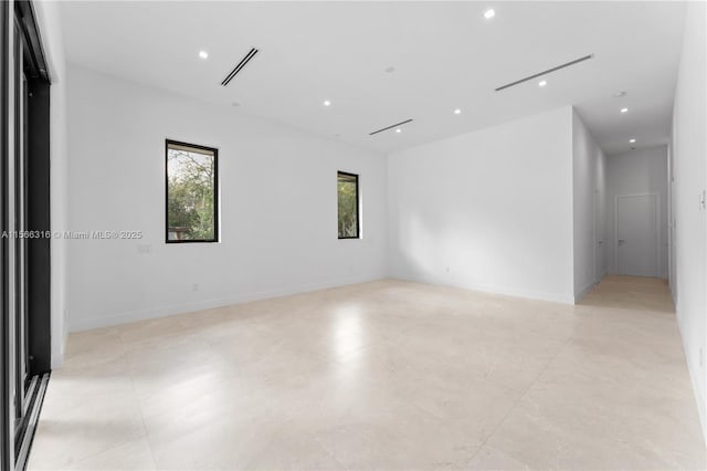 unfurnished room with recessed lighting, visible vents, and baseboards