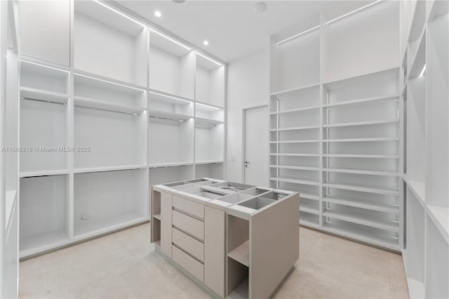 spacious closet with light tile patterned floors