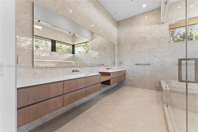 bathroom featuring vanity and tile walls