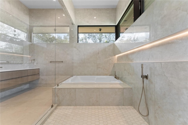 full bathroom featuring a shower, vanity, and a bath