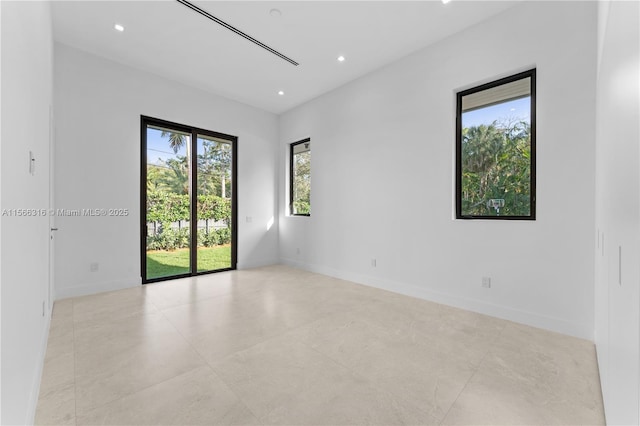 empty room with recessed lighting and baseboards