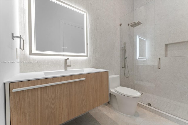 full bath with toilet, a stall shower, vanity, and tile patterned floors