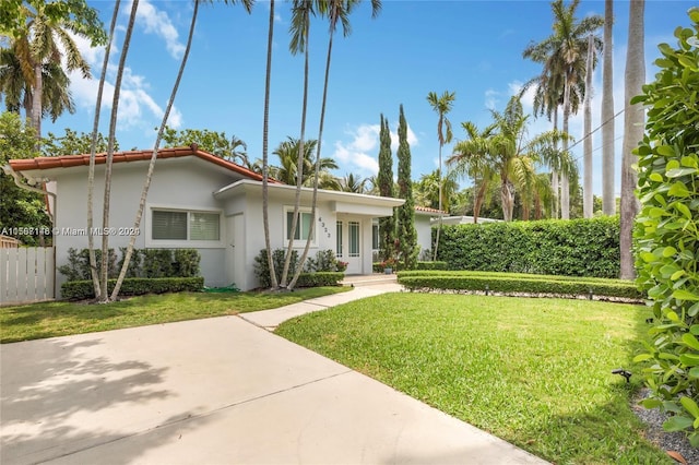 ranch-style home featuring a front yard