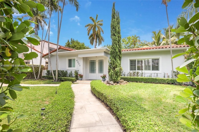 mediterranean / spanish-style house with a front yard