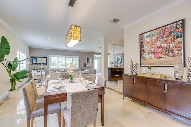 tiled dining space with crown molding