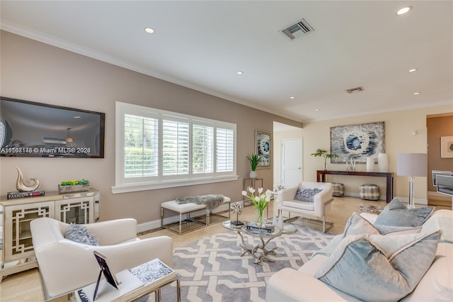 living room featuring crown molding and light hardwood / wood-style floors