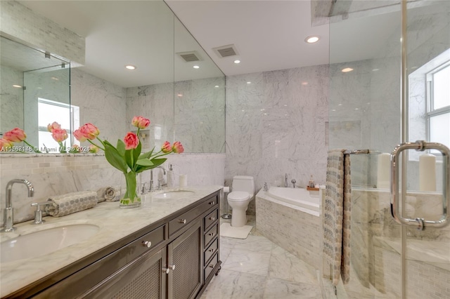 full bathroom featuring oversized vanity, tile flooring, toilet, double sink, and tile walls