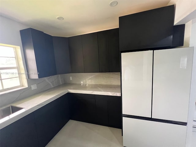 kitchen with white fridge and backsplash