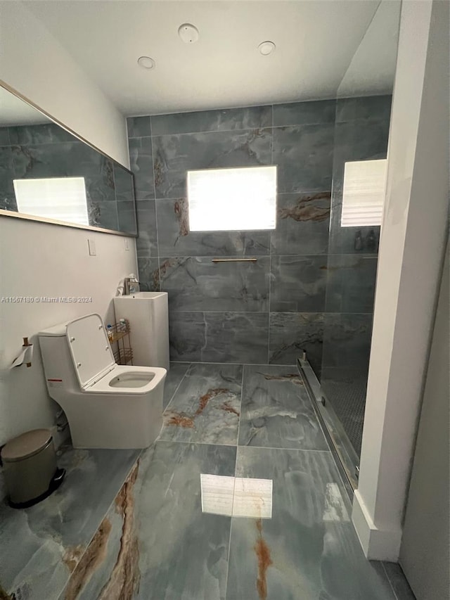 bathroom featuring tile walls, tile flooring, toilet, and a tile shower