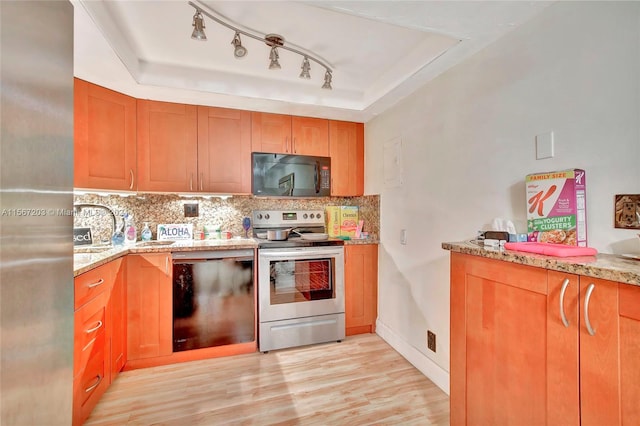 kitchen featuring light wood-type flooring, rail lighting, a raised ceiling, electric stove, and dishwasher