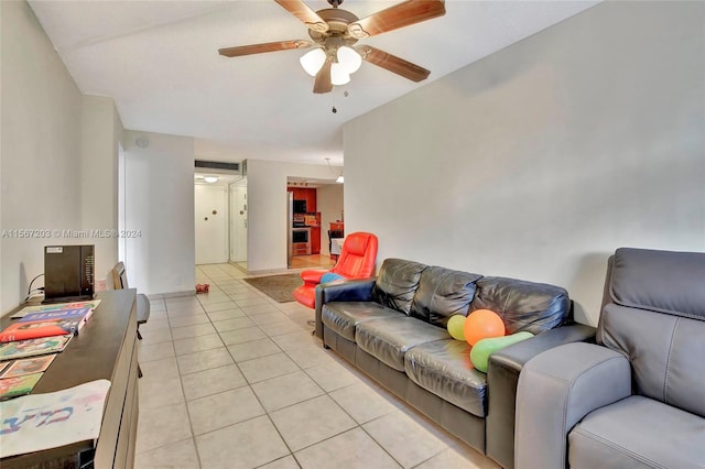 tiled living room featuring ceiling fan