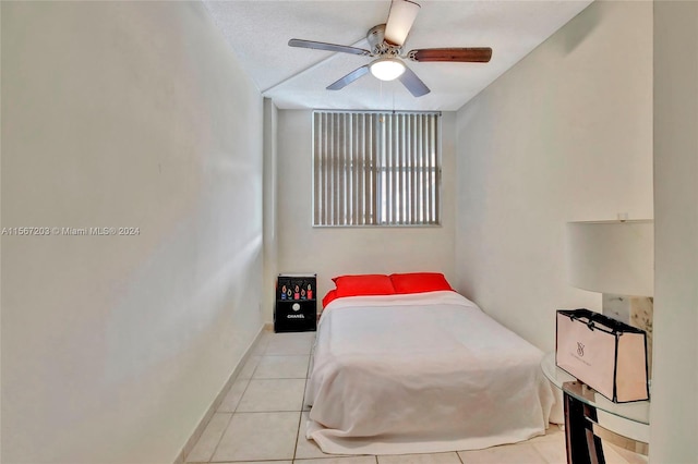 tiled bedroom featuring ceiling fan