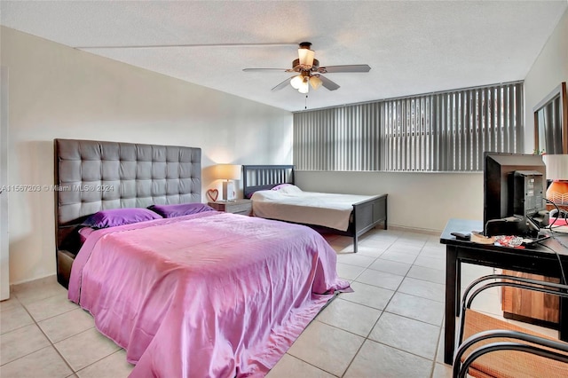 bedroom featuring a textured ceiling, ceiling fan, and light tile floors