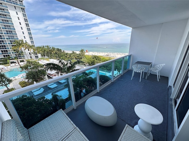 balcony with a beach view and a water view