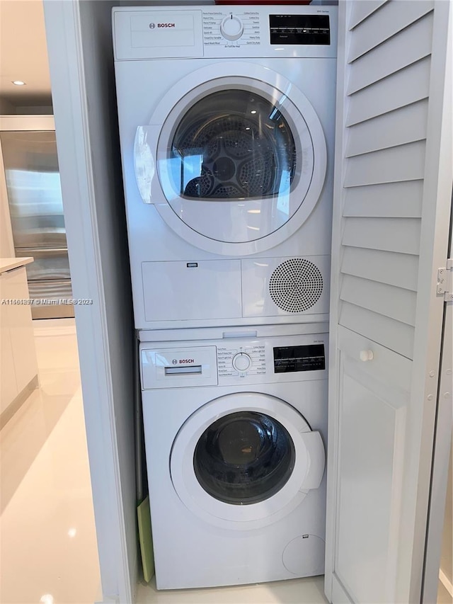 laundry area featuring stacked washer and clothes dryer