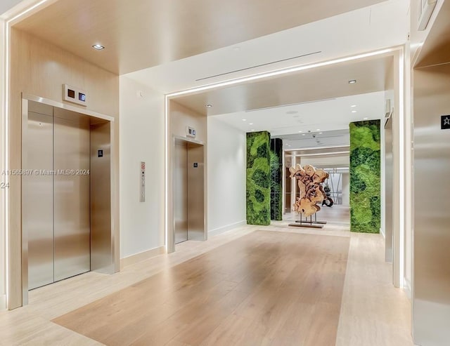 interior space featuring elevator and light hardwood / wood-style floors