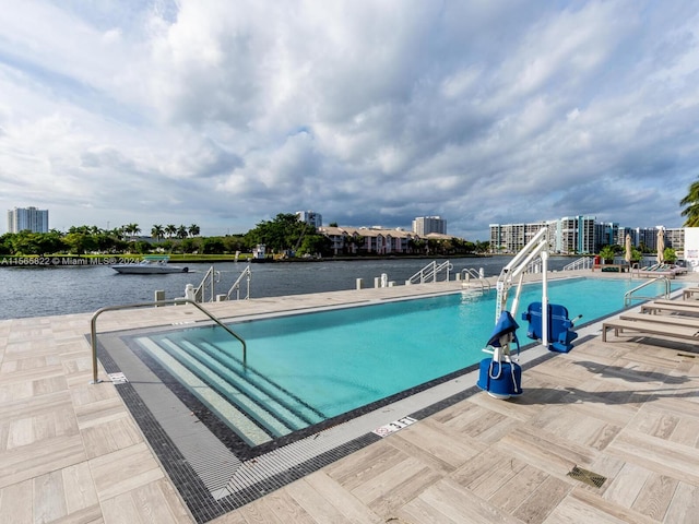 view of swimming pool with a water view