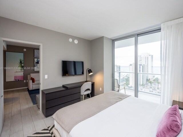 bedroom featuring access to outside and light hardwood / wood-style floors