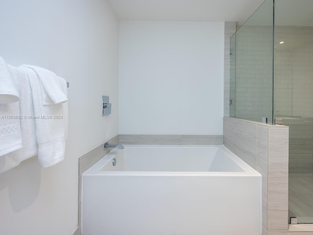 bathroom with shower with separate bathtub