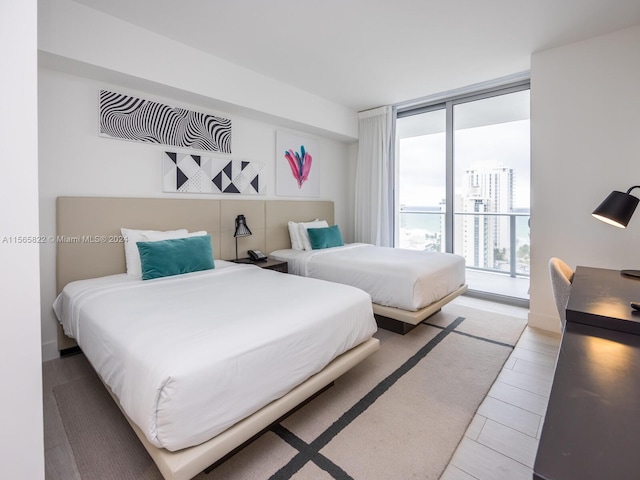 bedroom featuring floor to ceiling windows and access to outside