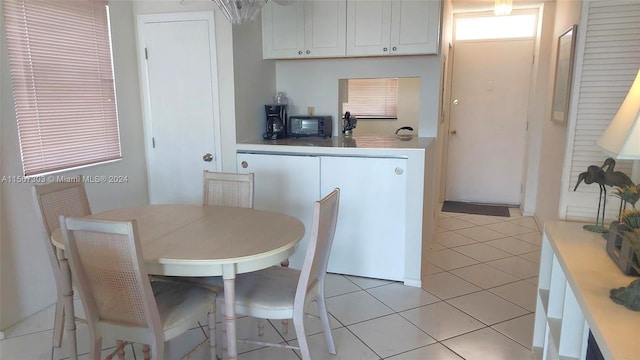 kitchen with white cabinetry and light tile patterned flooring