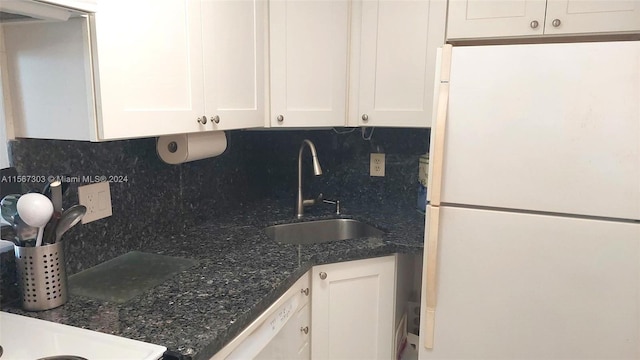 kitchen with sink, white appliances, decorative backsplash, and white cabinetry