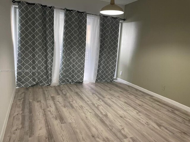 unfurnished room with light hardwood / wood-style floors