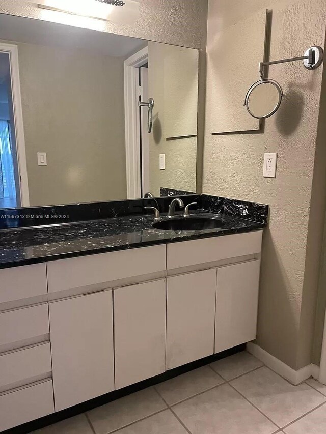 bathroom featuring tile floors and vanity