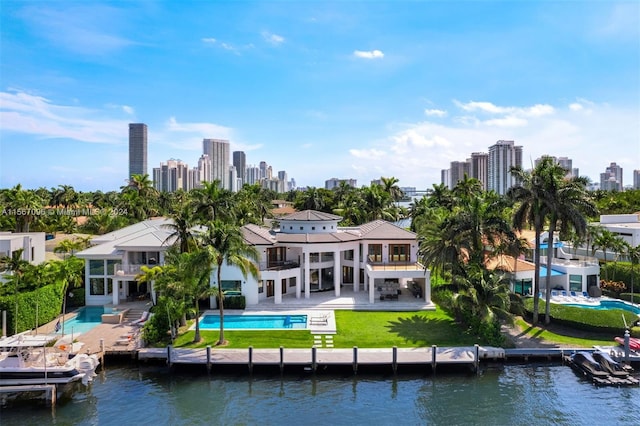 rear view of house featuring a balcony, a water view, and a patio area