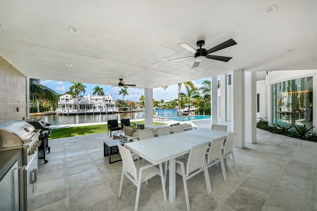 view of patio with ceiling fan, a water view, and area for grilling