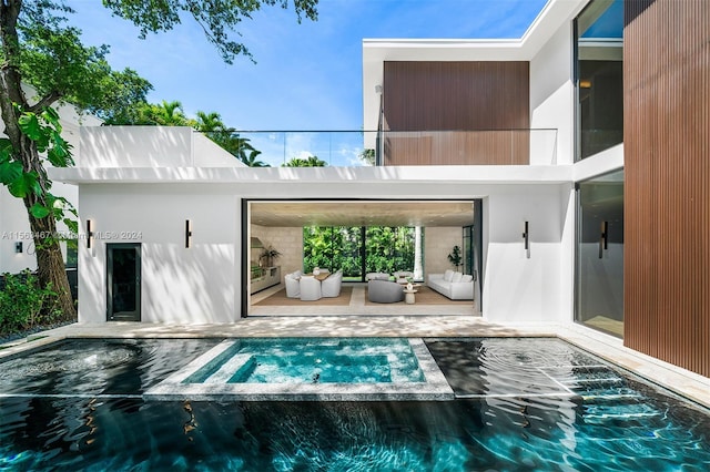 rear view of property with an outdoor hangout area