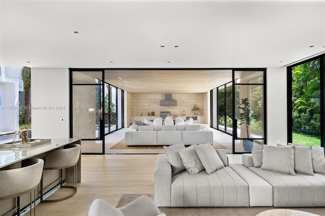 living room with expansive windows and light wood-type flooring