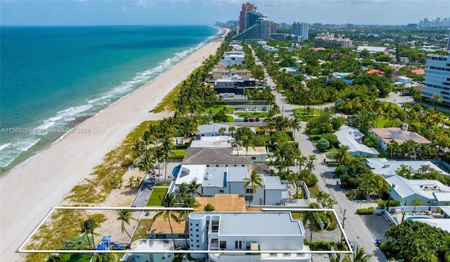 drone / aerial view featuring a view of the beach and a water view