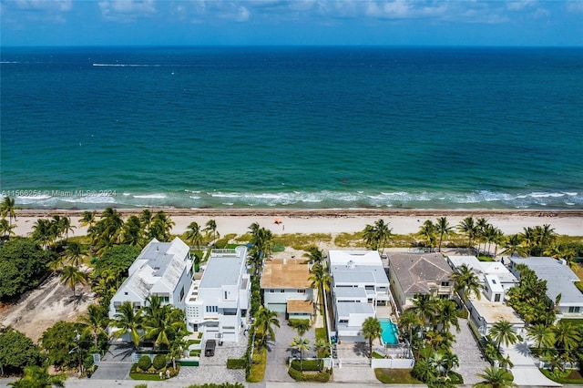 drone / aerial view with a water view and a view of the beach