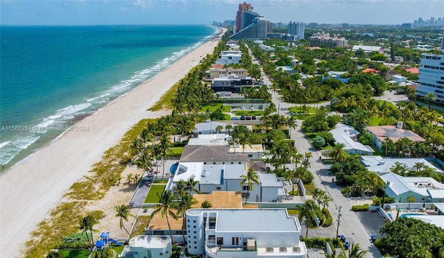 birds eye view of property featuring a beach view and a water view