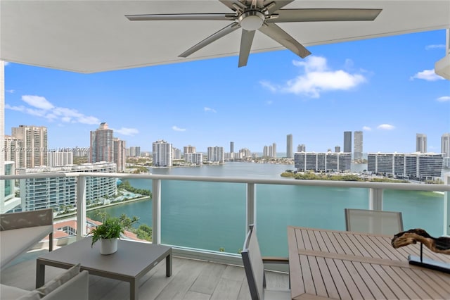 balcony with a water view and ceiling fan